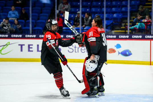 Makoto Ito of Japan celebrates with goaltender Riko
