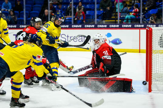 Lina Ljungblom of Sweden and goaltender Riko Kawaguchi of