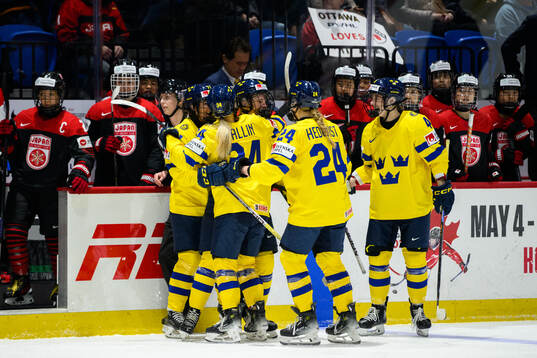 Thea Johansson of Sweden celebrates with teammates