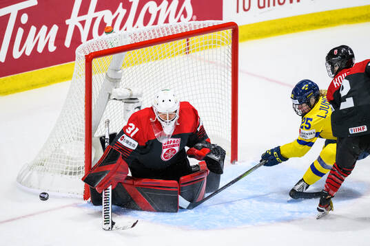 Goaltender Riko Kawaguchi of Japan and Lina Ljungblom of