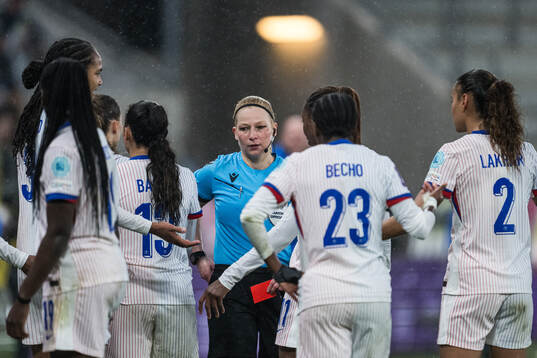 Referee Ewa Augustyn shows a red card