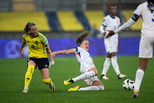 Kosovare Asllani of Sweden and Sandie Toletti of France