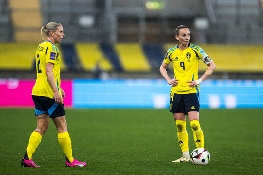 Jonna Andersson and Kosovare Asllani of Sweden looks