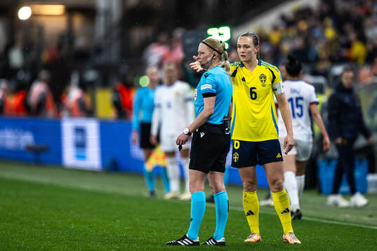 Referee Ewa Augustyn and Magdalena Eriksson of Sweden