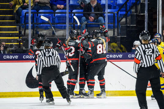 Renata Fast of Canada celebrates with teammates