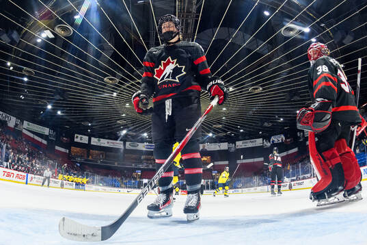 Ashton Bell and goaltender Emerance Maschmeyer of Canada
