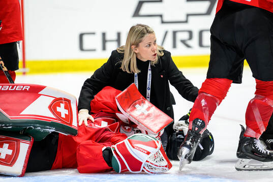 Goaltender Andrea Braendli of Switzerland recieves medical