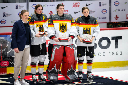 Laura Kluge, goaltender Sandra Abstreiter and Strobel of