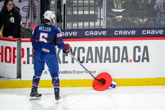 Megan Keller of USA picks up a thrown in object