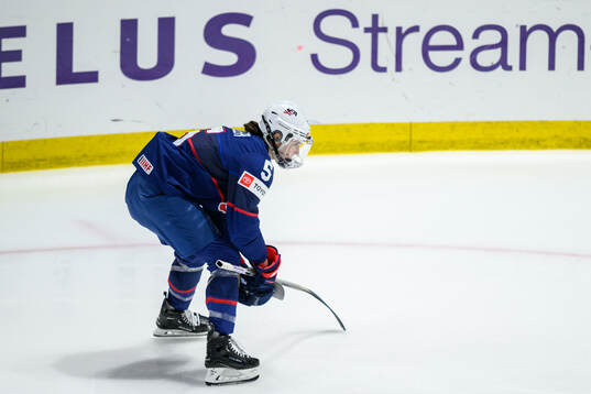 Megan Keller of USA picks upp objects
