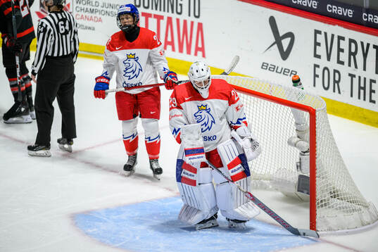 Vendula Pribylova and goaltender Klara Peslarova of Czech