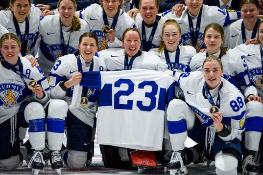 Players of Finland celebrate with a jersey dedicated to