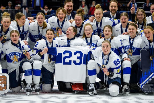 Players of Finland celebrate with a jersey dedicated to