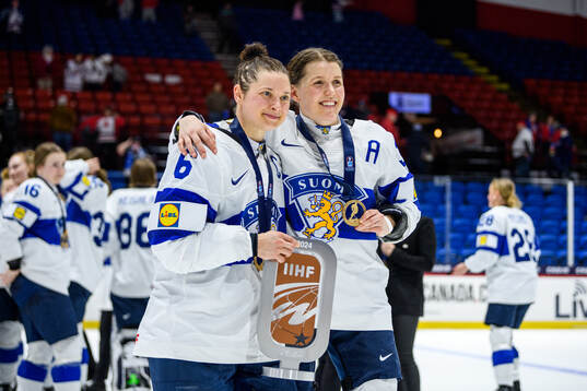 Jenni Hiirikoski and Michelle Karvinen of Finland celebrate