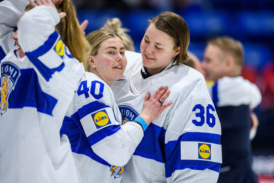 Noora Tulus and goaltender Anni Keisala of Finland