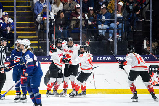 Marie-Philip Poulin of Canada celebrates with teammates