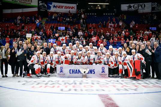Players and staff of Canada celebrate