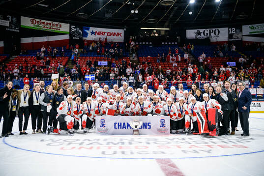 Players and staff of Canada celebrate