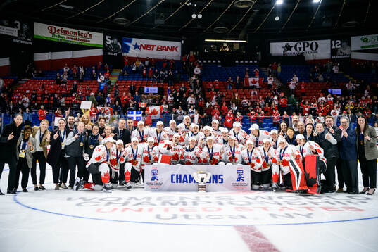 Players and staff of Canada celebrate
