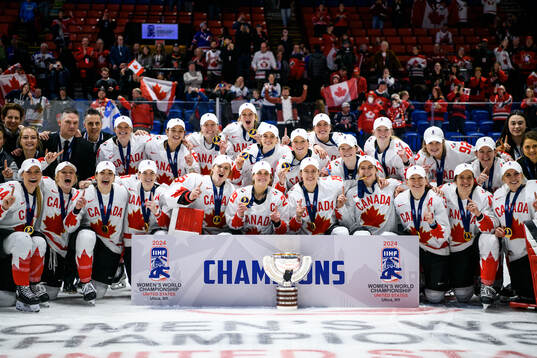 Players and staff of Canada celebrate