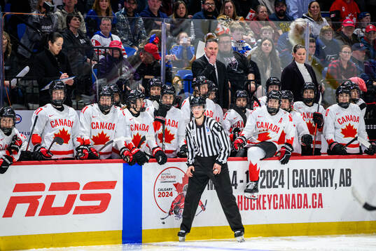 Head coach Troy Ryan and players of Canada