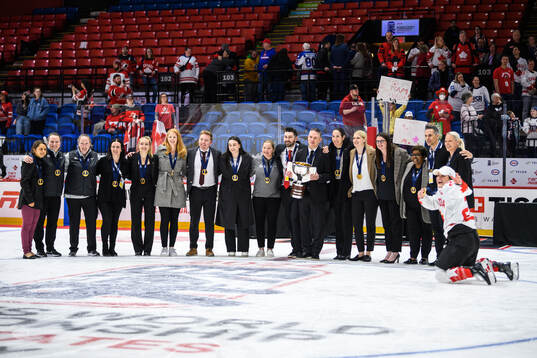 Staff and Marie-Philip Poulin of Canada