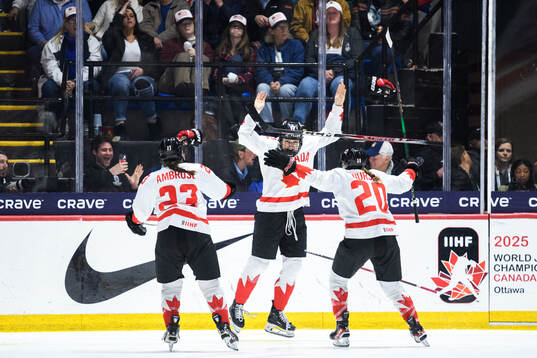 Danielle Serdachny of Canada celebrates with teammates