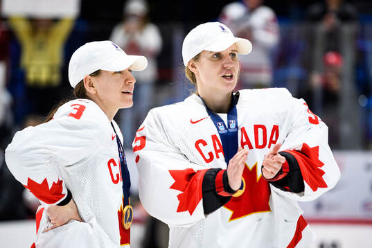 Jocelyne Larocque and goaltender Ann-Renee Desbiens of