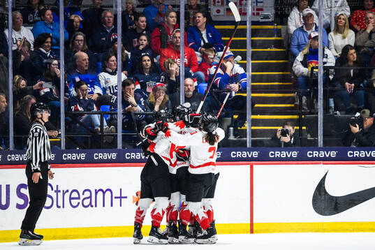 Marie-Philip Poulin of Canada celebrates with teammates