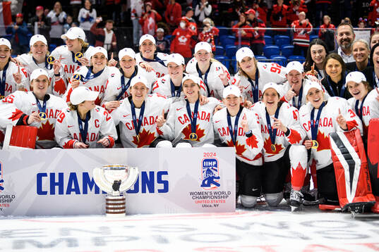 Players and staff of Canada celebrate
