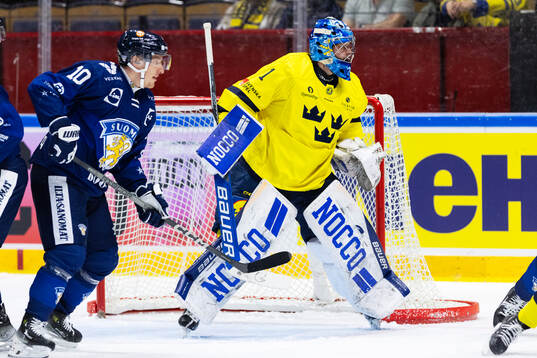 Eemeli Suomi of Finland and goalkeeper Filip Larsson of