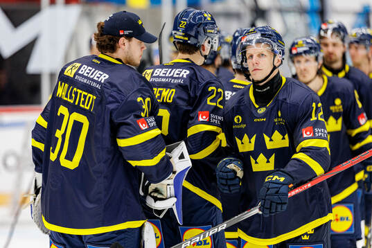 Goaltender Jesper Wallstedt and Max Friberg of Sweden look