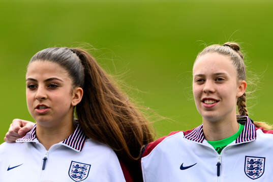 Isabella Fisher and goalkeeper Rebekah Dowsett of England
