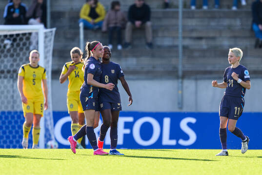 Nelly Las and Omotara Junaid of England celebrate