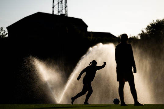 A silhouette of a player warming up