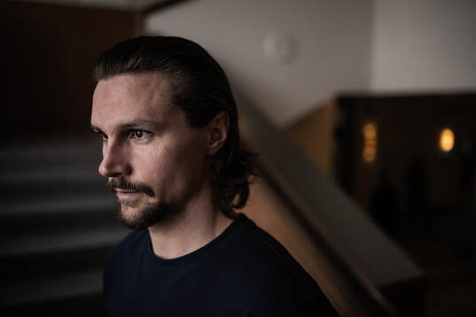 Erik Karlsson poses for a portrait at a press event with