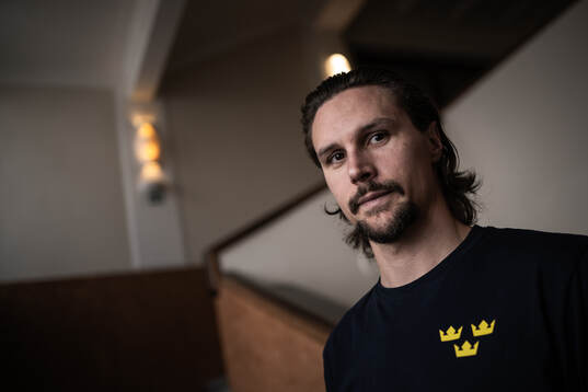 Erik Karlsson poses for a portrait at a press event with
