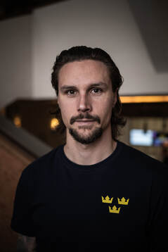 Erik Karlsson poses for a portrait at a press event with