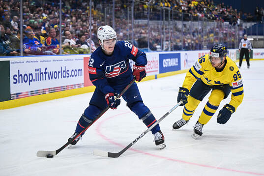 Cole Caufield of USA and André Burakovsky of Sweden