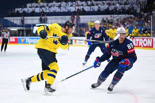 André Burakovsky of Sweden and Jake Sanderson of USA