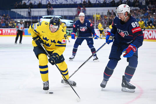 André Burakovsky of Sweden and Jake Sanderson of USA