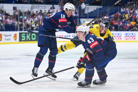 Matt Boldy of USA and Luke Huges against Joel Eriksson Ek