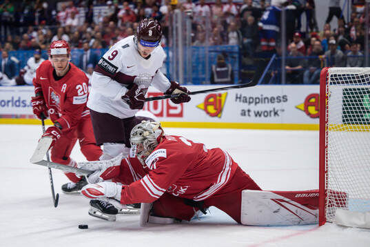 Renars Krastenbergs of Latvia and goaltender John Murray of