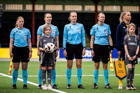 Referee Lotta Vuorio with assistant referees Katrine