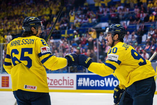 Erik Karlsson and Marcus Johansson of Sweden celebrates