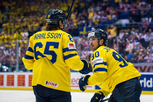 Erik Karlsson and Marcus Johansson of Sweden celebrate
