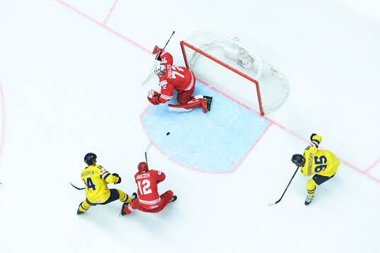 Marcus Johansson of Sweden (not pictured) scores 1-0 behind