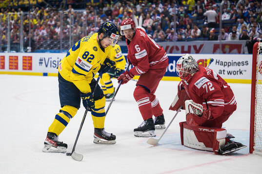 Jesper Frödén of Sweden and goaltender David Zabolotny of