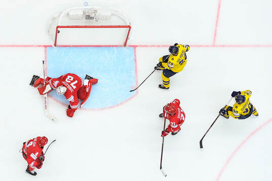 Patryk Wajda, goaltender David Zabolotny and Pawel Dronia