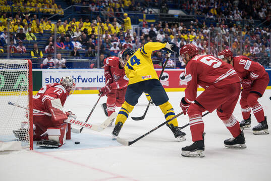 Goaltender David Zabolotny of Poland and Joel Eriksson Ek